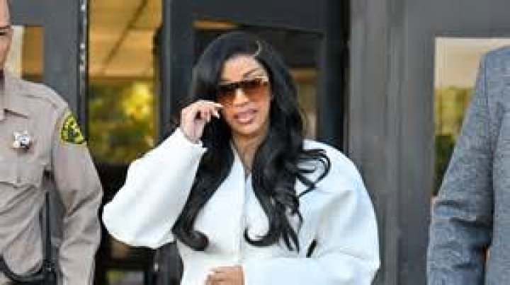 Cardi B Rocks Bright Pink Plunging Suit With Nothing Underneath & Wild Nails For Latest Court Appearance