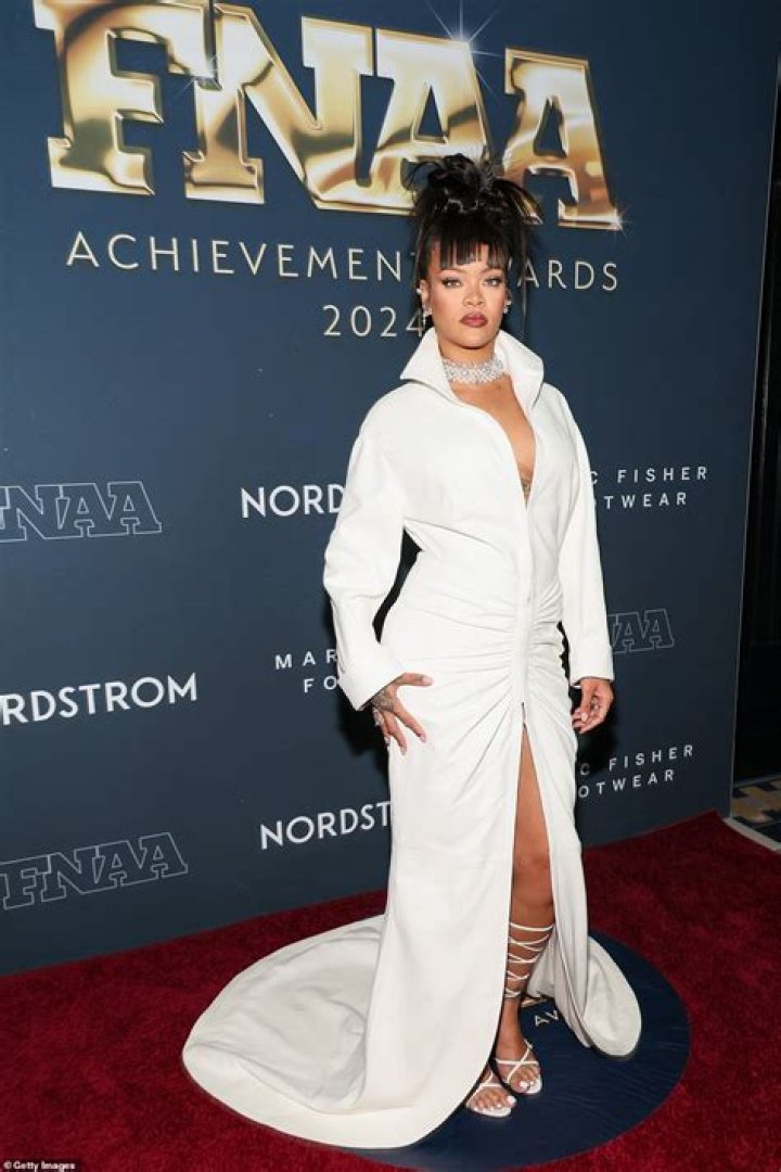 Cardi B Rocks Elegant Feathers As She Licks Her Footwear News Achievement Award During Speech