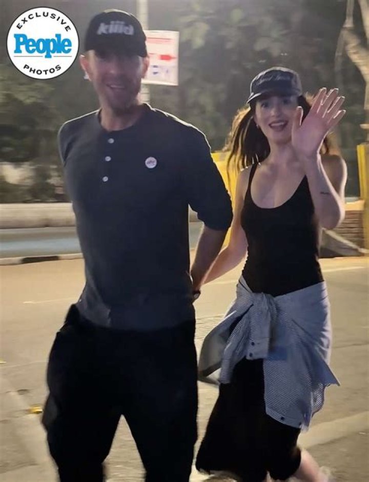 Dakota Johnson & Chris Martin Hold Hands In Rare PDA Photos After Her Movie Premiere