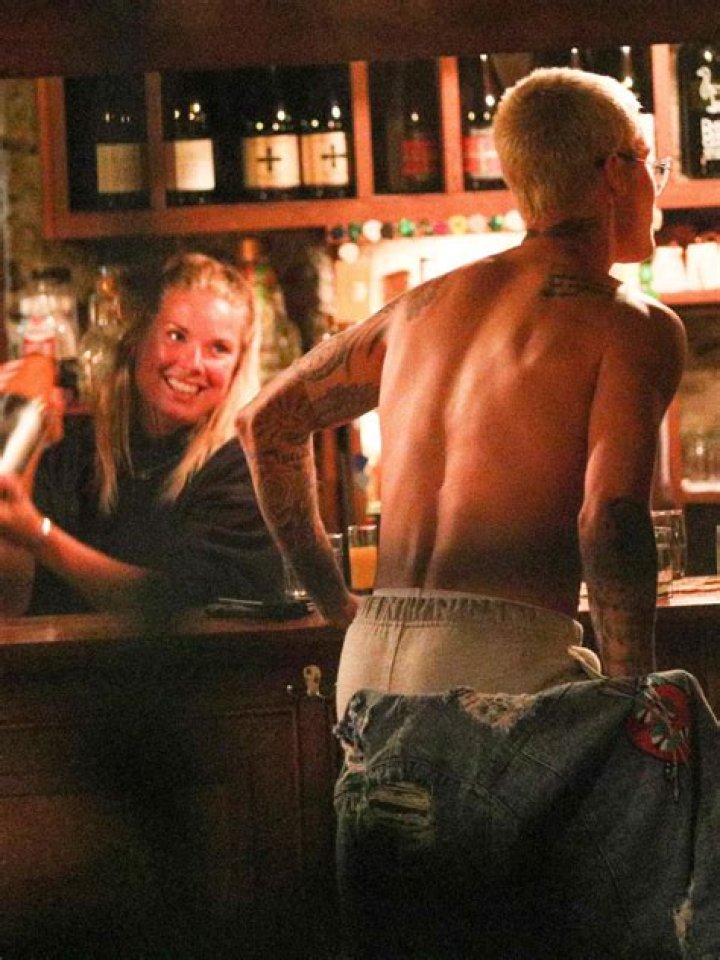 Justin Bieber Takes Shots & Flirts With Bartender While Shirtless In A Bar — See Wild Pics