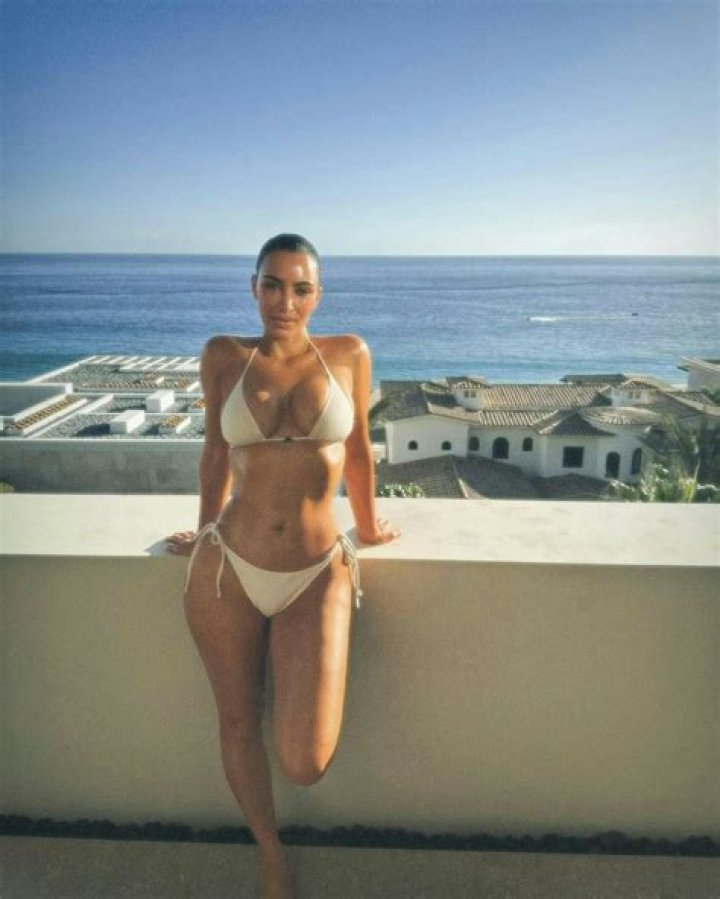 Kim Kardashian Teases New Makeup Collection Wearing Crochet Bra & Floral Headpiece In New Photos