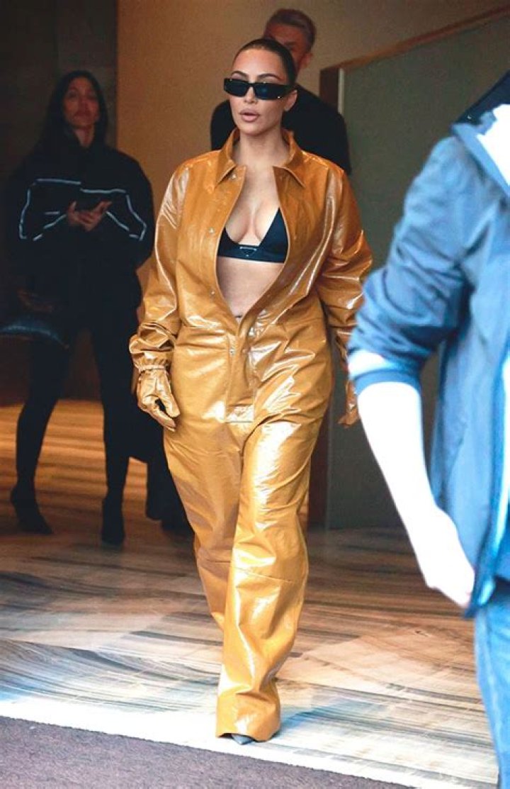 Kim Kardashian Shows Off Lingerie In Plunging Gold Leather Jumpsuit At Milan Fashion Week