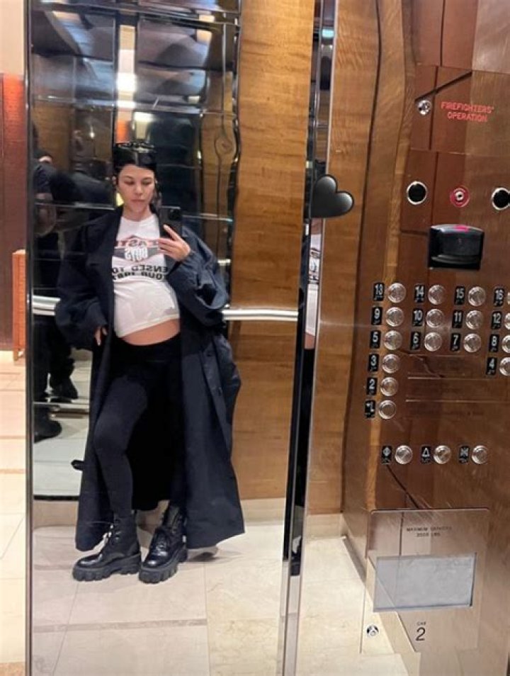 Kourtney Kardashian’s Baby Bump Peeks Out Of Her T-Shirt In Pregnant Elevator Selfie