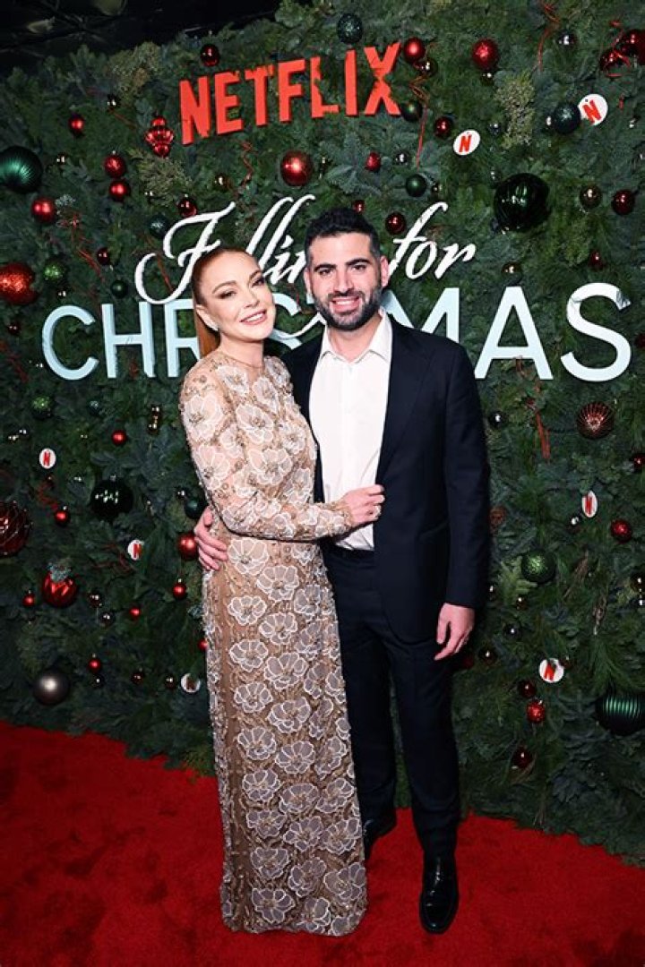 Lindsay Lohan Cozies Up To Husband Bader Shammas In Floral Dress For ‘Falling For Christmas’ Premiere