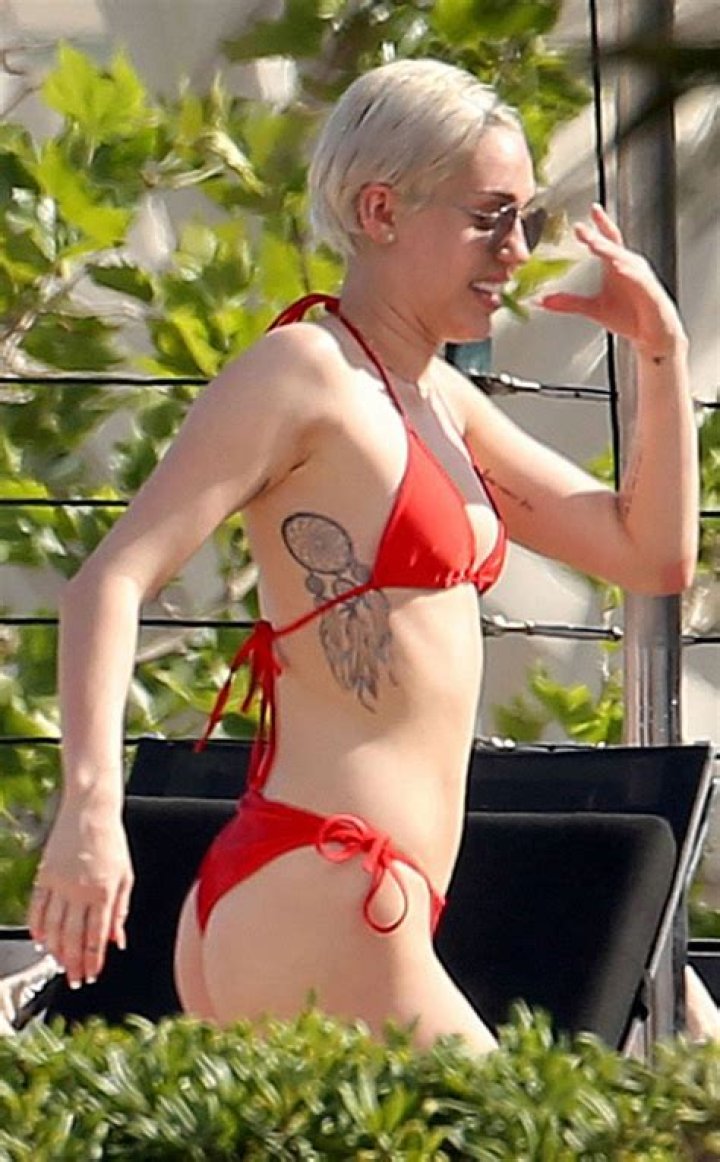 Miley Cyrus Wears A Black String Bikini As She Goes For A Dip In Her Pool & Jokes She’s An ‘Avocad-ho’
