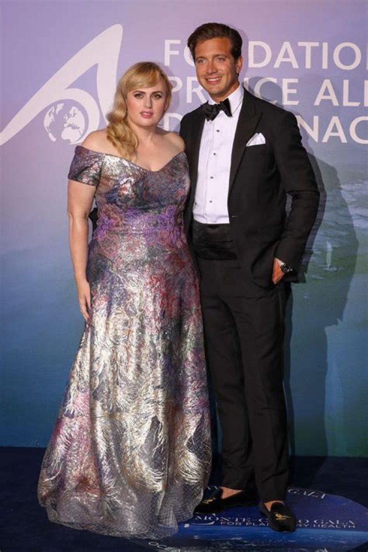 Rebel Wilson Gets A Sweet Kiss From BF Jacob Busch While Stunning In White Dress On Date Night