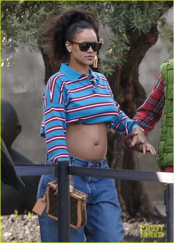 Rihanna Shows Off Bare Baby Bump In Plunging Crop Top & Low-Rise Jeans