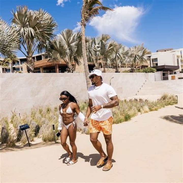Simone Biles Cuddles Fiancé Jonathan Owens While Wearing $500 Burberry Swimsuit